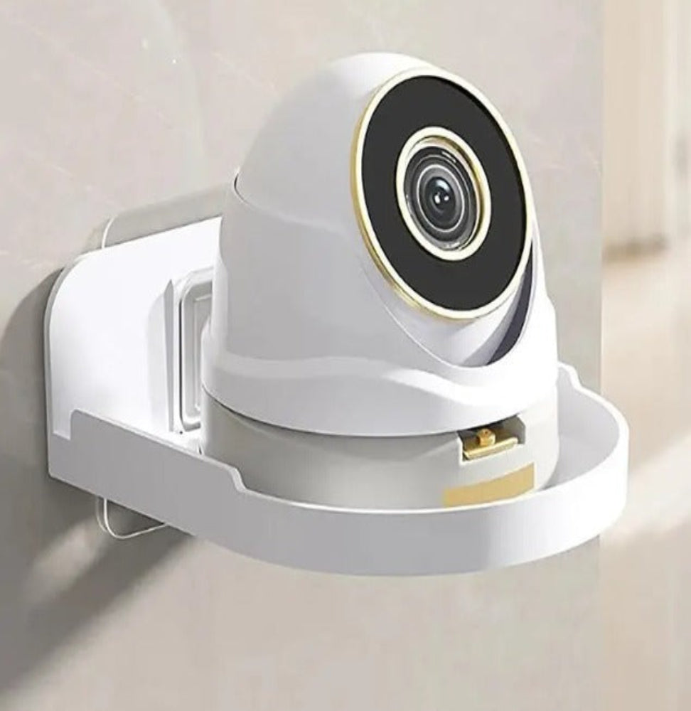 Transparent acrylic corner shelf holding a white security camera