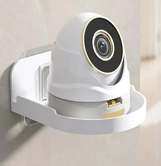 Transparent acrylic corner shelf holding a white security camera